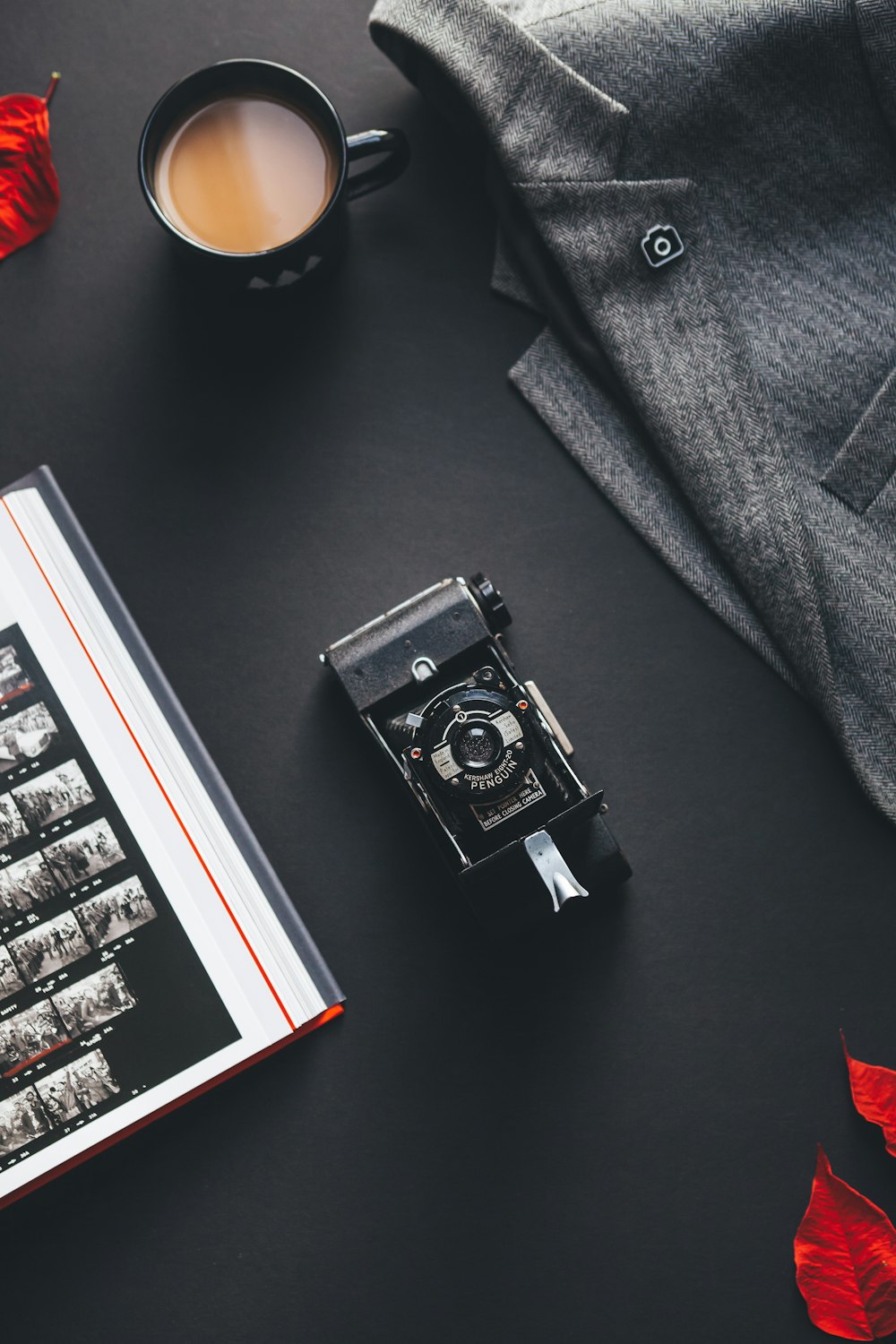 black film camera near gray suit jacket