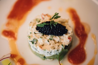 A sophisticated platter of various caviar types adorned with garnishes.