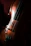 Close-up of a violin's polished emerald-green finish gleaming under soft spotlight.