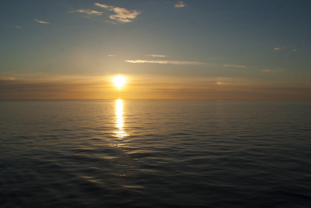 body of water during sunset