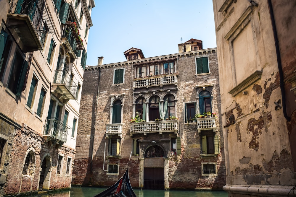 brown concrete building and body of water