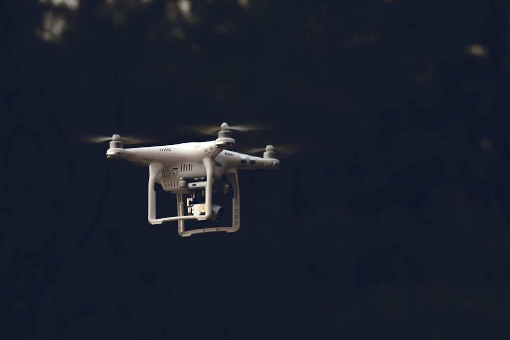 white DJI phantom-series quadcopter flying during daytime