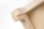 A close-up view of a wooden corner joint, displaying the intricate pattern of layered wood grain and precise craftsmanship. The natural wood color gives it a simple yet elegant appearance.