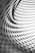 A curved facade covered in white latticework