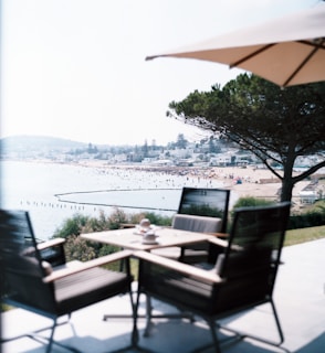 A scenic view of a coastal venue with people enjoying the outdoors.