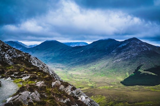 brown and black mountains under blue sky during daytime in Connemara National Park Ireland