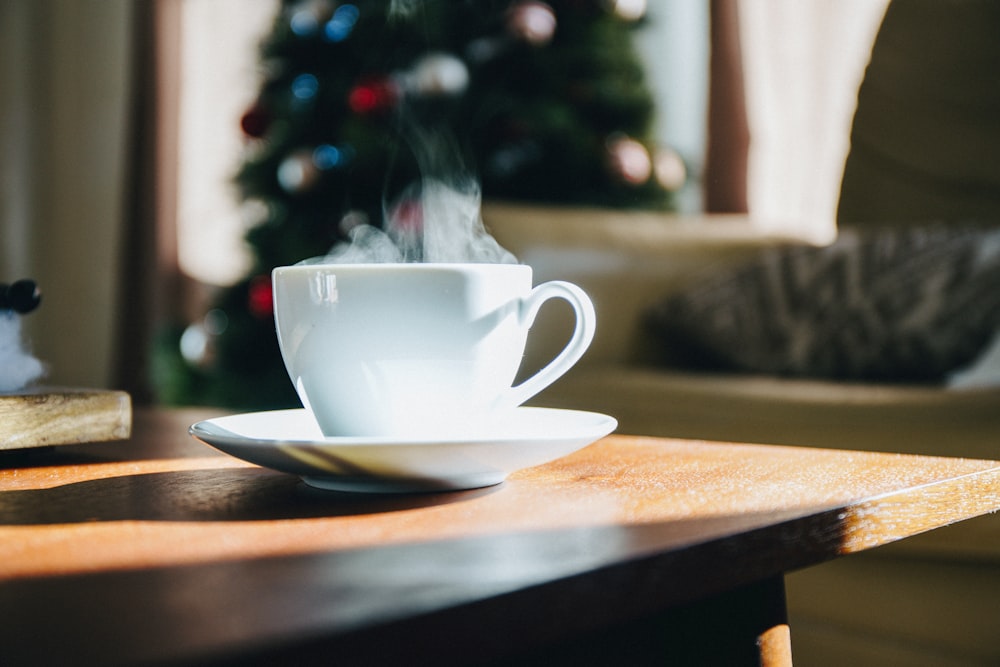 white teacup on top of brown table