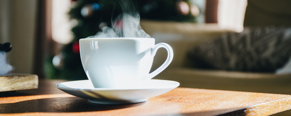 white teacup on top of brown table