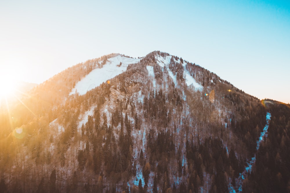 brown and white mountain under blue sky at golden hour