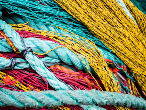 Colorful ropes coiled neatly in a workshop, highlighting texture and strength