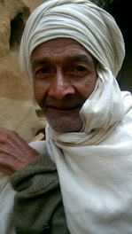 A serene portrait of Sheikh Suleiman in a peaceful natural setting, reflecting his spiritual healing practice.