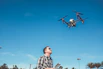 man flying drone