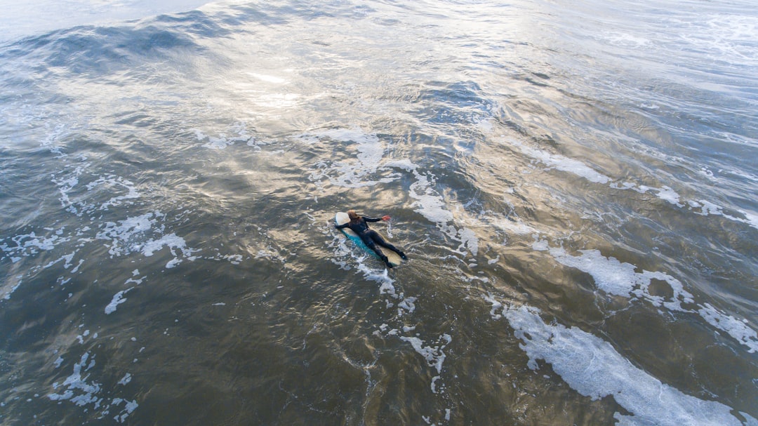 man surfboarding during daytime