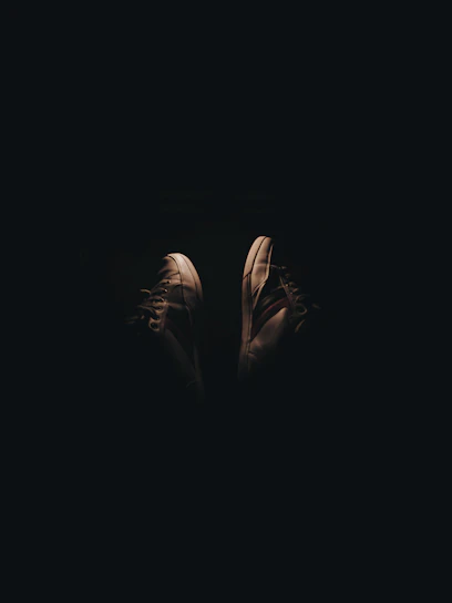 Close-up of a restored pair of classic Jordan 1 sneakers on a dark background