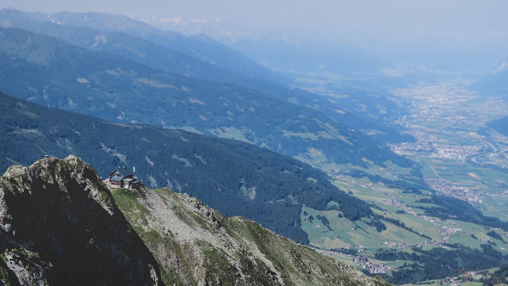 person sitting on rock mountain during daytime