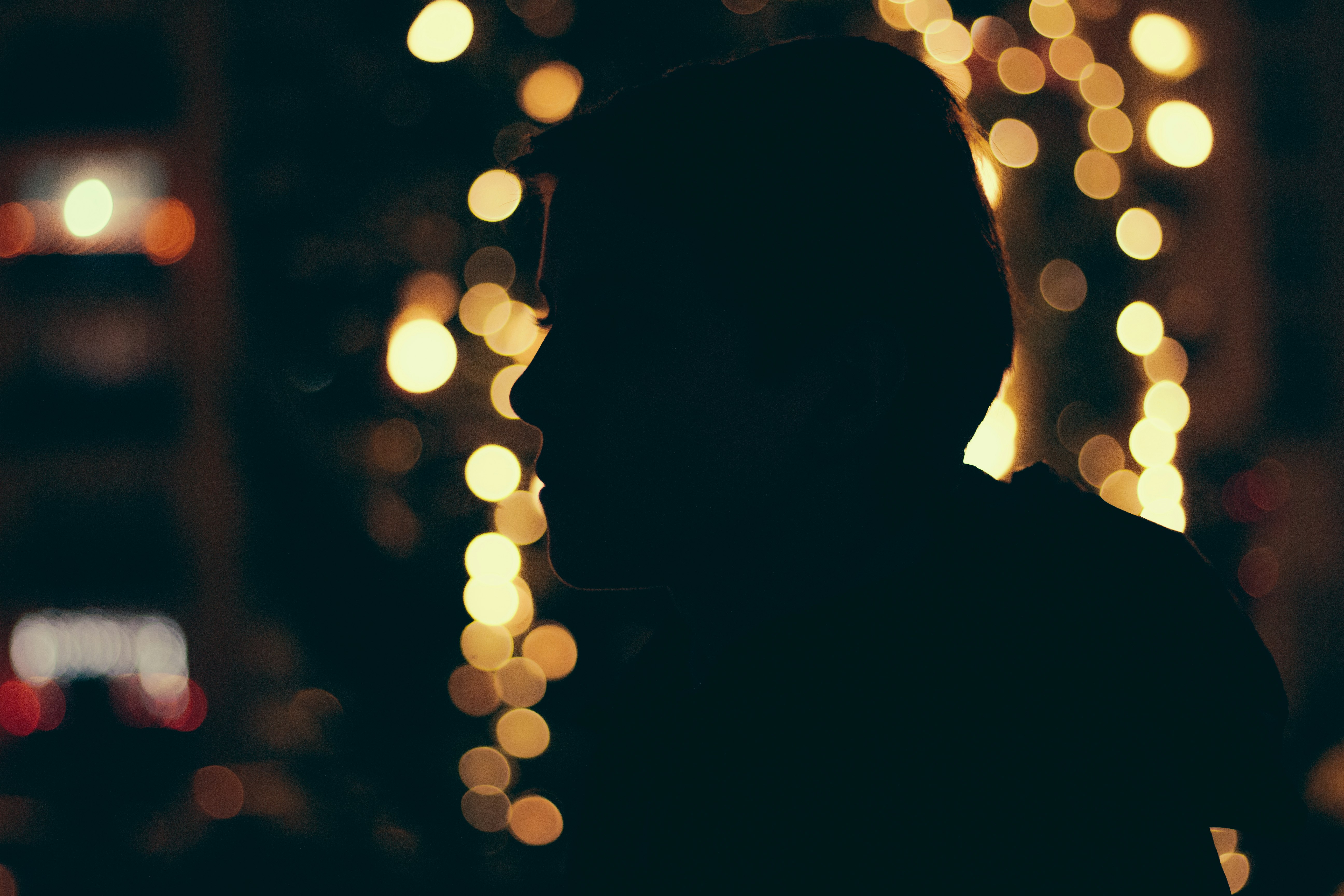 silhouette of man with bokeh lights