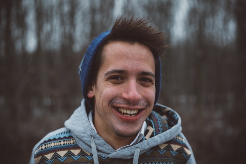 shallow focus photography of a man smiling while taking picture