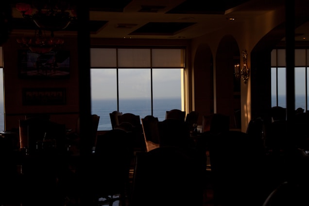 Cozy dining area with ocean view and elegant nautical decor at Ocean’s Seafood and Grill.