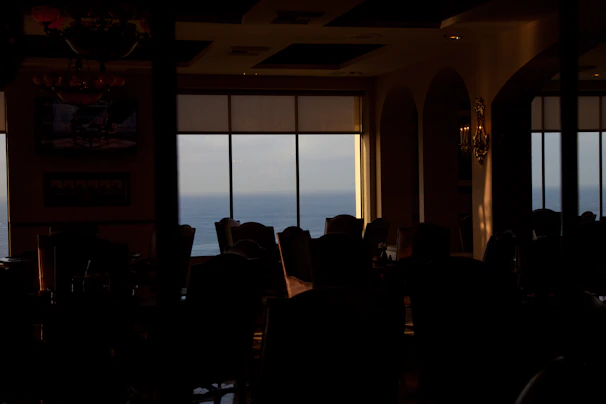 Elegant onboard dining experience with panoramic ocean views and ambient lighting.