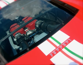 Close-up of a car engine with sound waves visualized as digital data overlays.