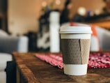 white plastic cup on brown surface