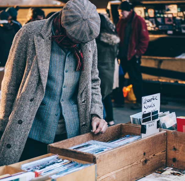 person looking in box filled with books