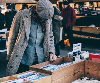 person looking in box filled with books