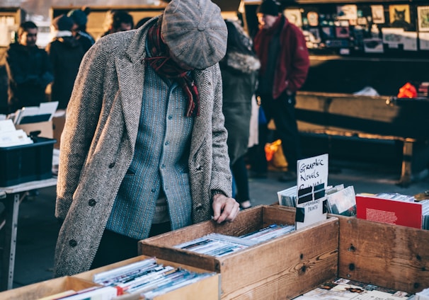 person looking in box filled with books