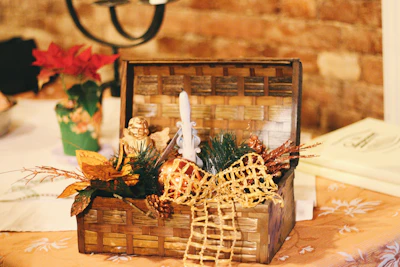 A rustic wooden basket filled with traditional Roman delicacies and festive decorations.
