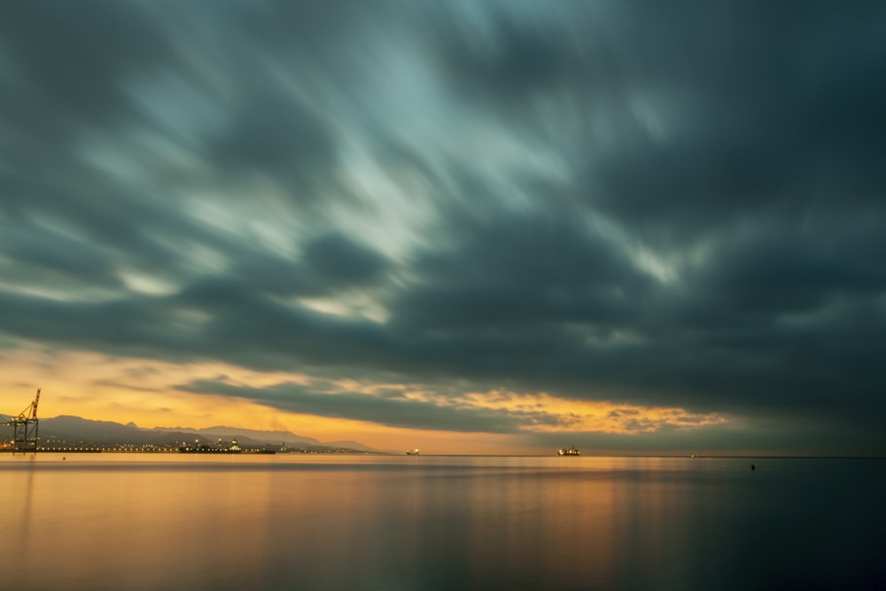 body of water under the cloudy sky