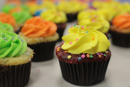 A colorful assortment of cupcakes with vibrant frosting and sprinkles.