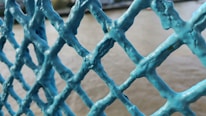 Close-up of a modern steel fence with a navy blue background.