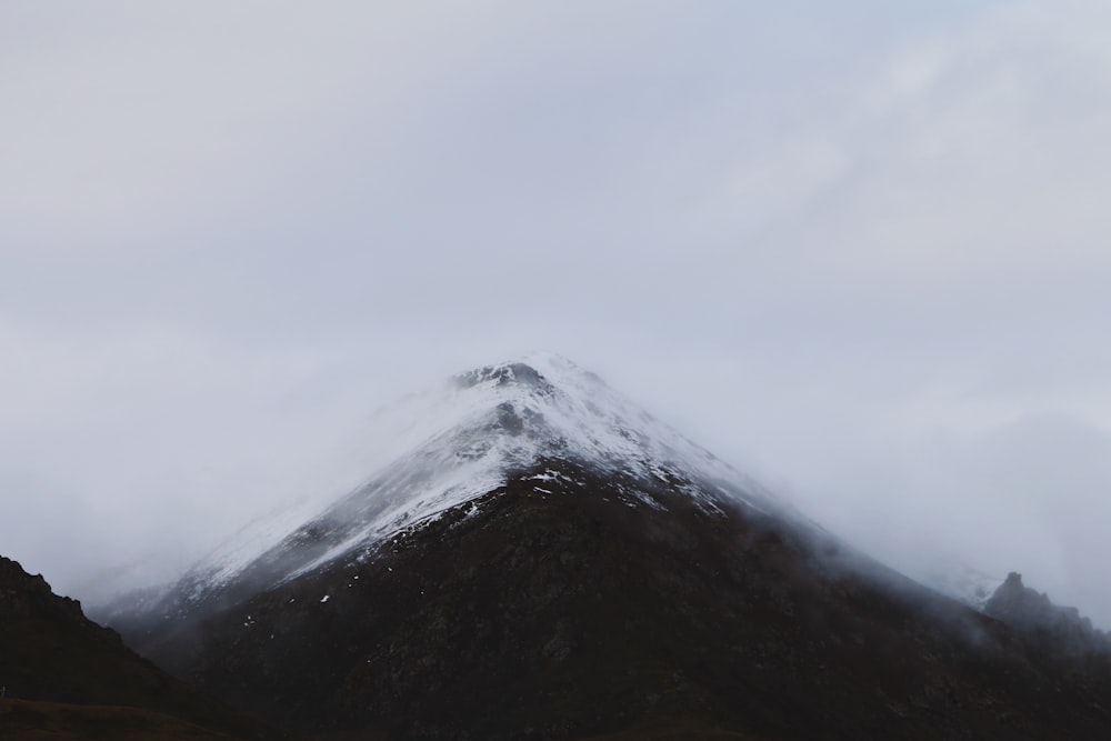 snow mountain summit under clouds