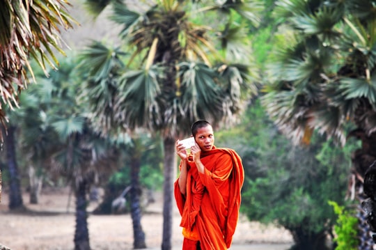 shallow focus photography of man walking in Angkor Wat Cambodia