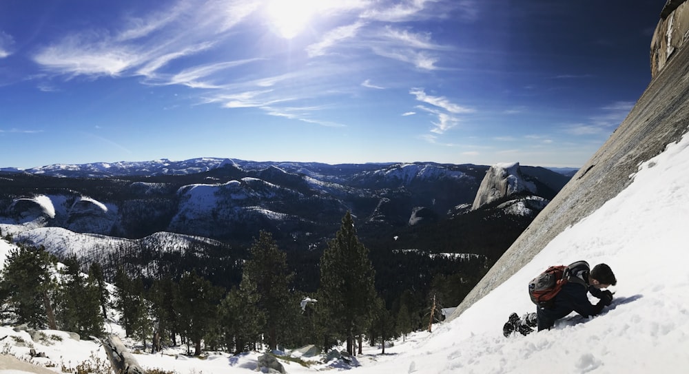 man climbing on snow