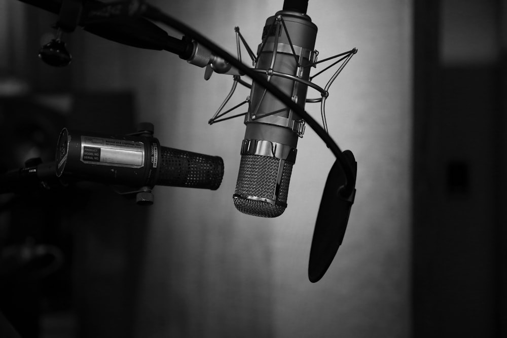 grayscale photography of condenser microphone with pop filter