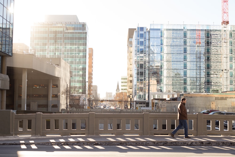 man walking beside road during daytime