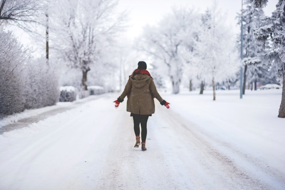 person walking on snow path