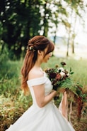 woman wearing white off-shoulder wedding gown wearing white petaled flower
