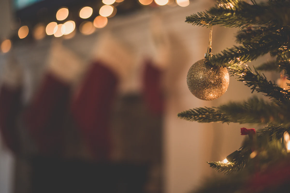 Measuring and setting up the base of a fresh-cut Christmas tree.