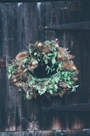 A rustic farmhouse wreath made of dried twigs and herbs.