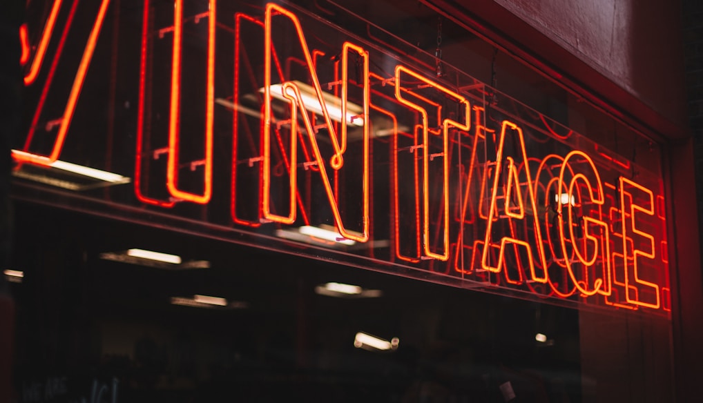 red neon signage on glass wall