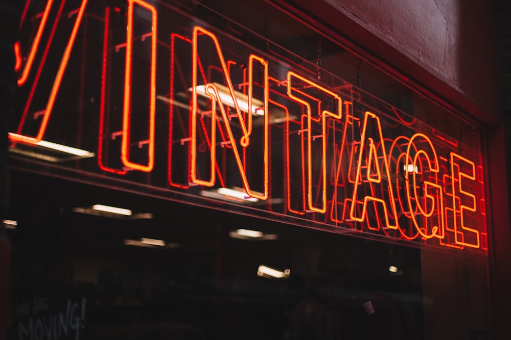 red neon signage on glass wall