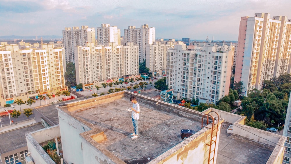 man standing on top of building