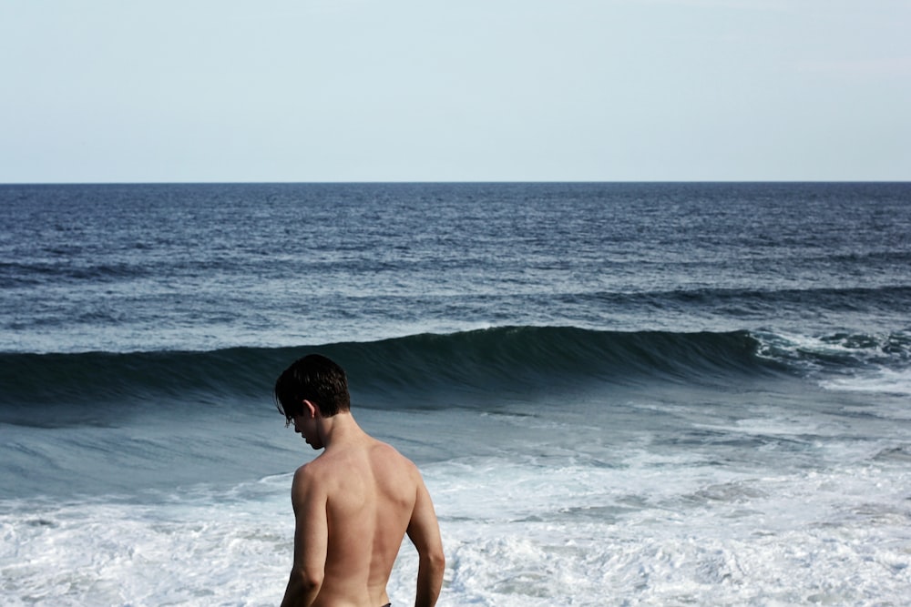 Mann steht vor dem Ozean