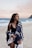woman wearing monokini and standing on seashore