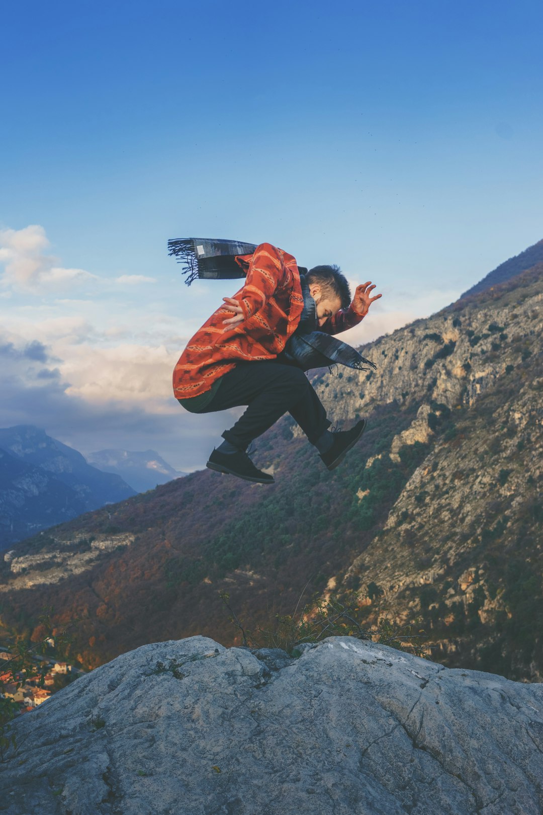 man doing stunt on cliff during daytime