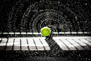 A player mid-throw, water splashing dynamically around during a competitive match.