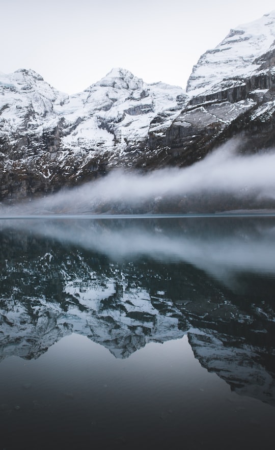reflection photography of mountains in Oeschinen Lake Switzerland