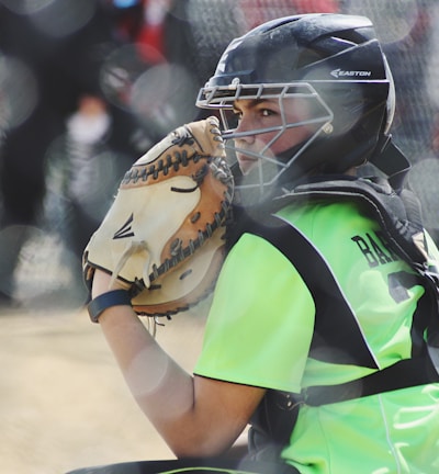 woman wearing brown Easton baseball mitt playing baseball